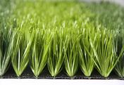 Dense, bright green artificial turf (synthetic grass) close-up.